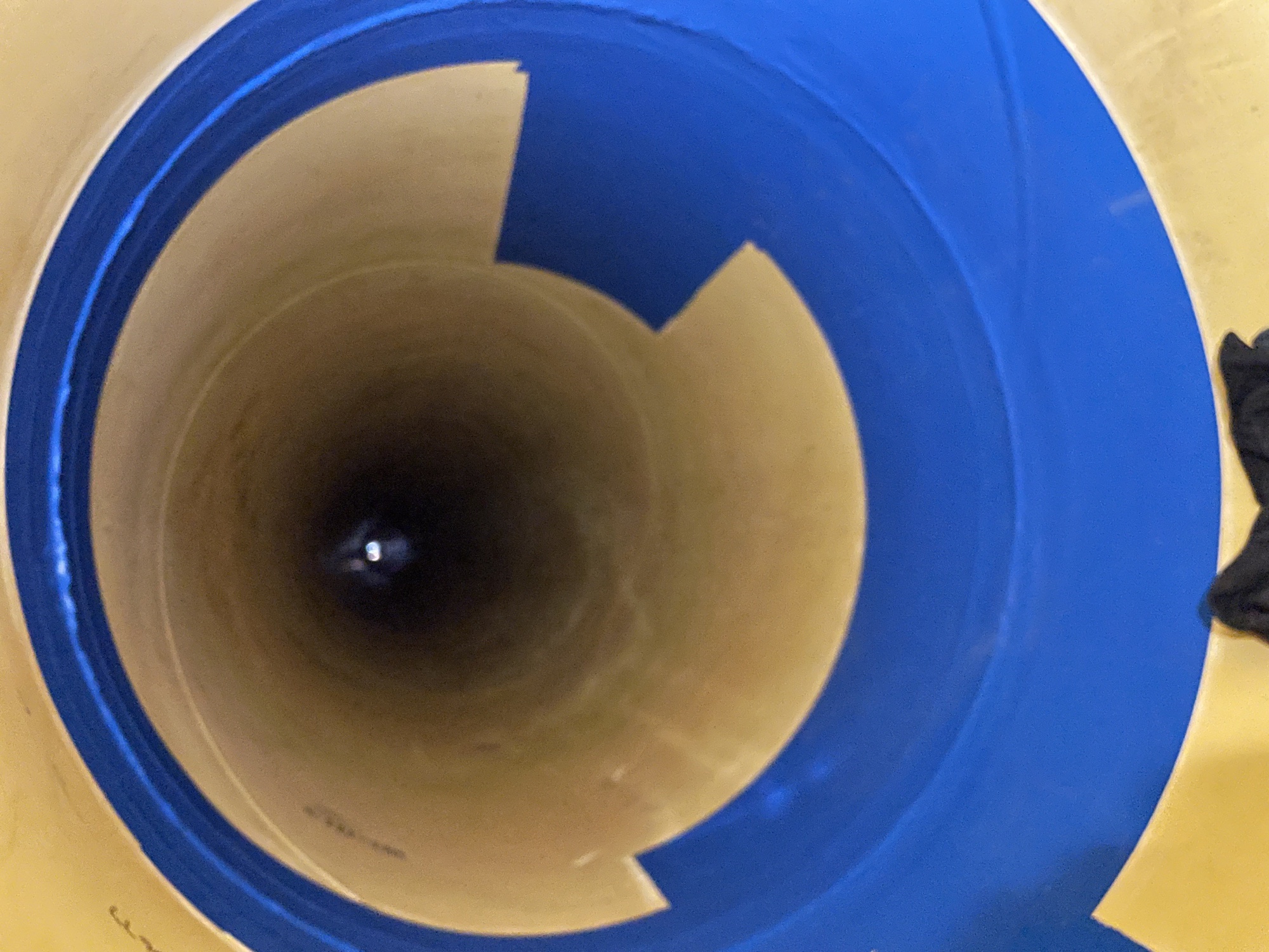 Completed blue protective coating viewed through the inside of a large-diameter lined pipe